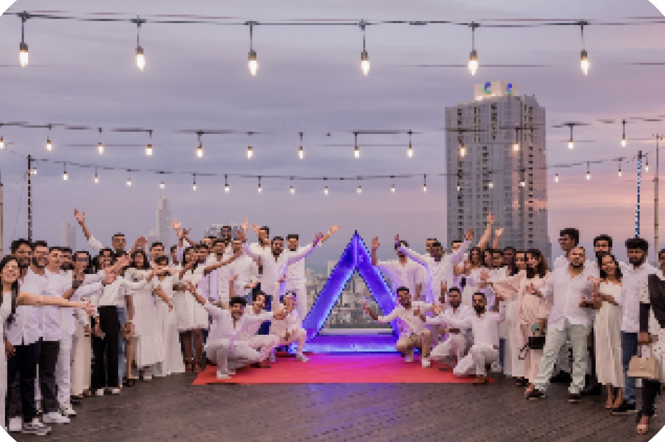 The AuroraRCM team celebrating on a rooftop at sunset