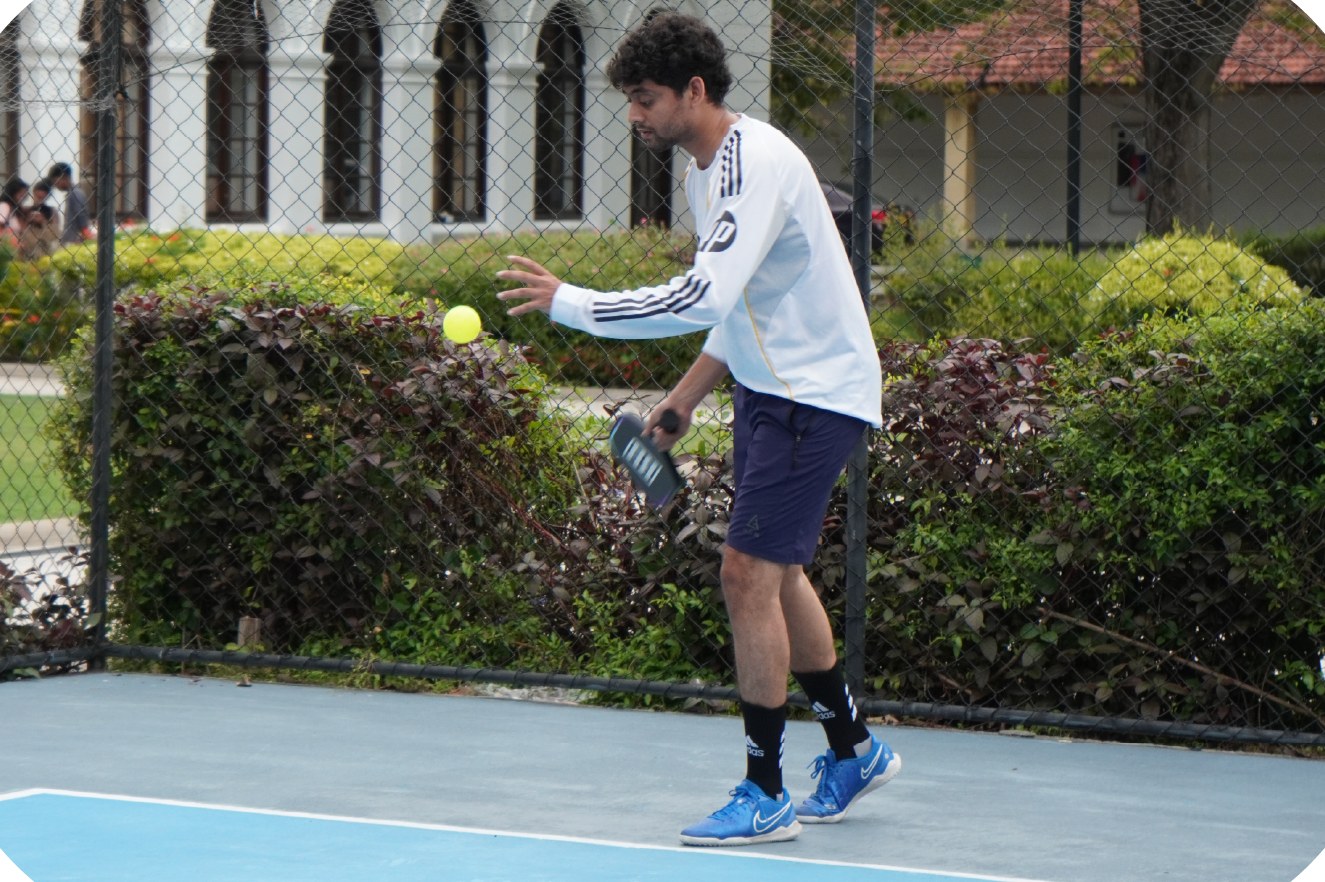 A team member playing pickleball at a company sports day